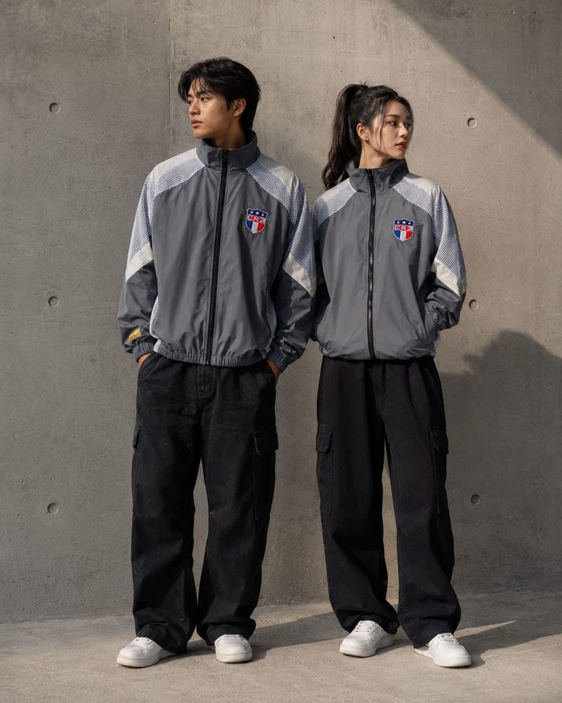 A man and a woman wearing the same HiGHKEY tracksuit